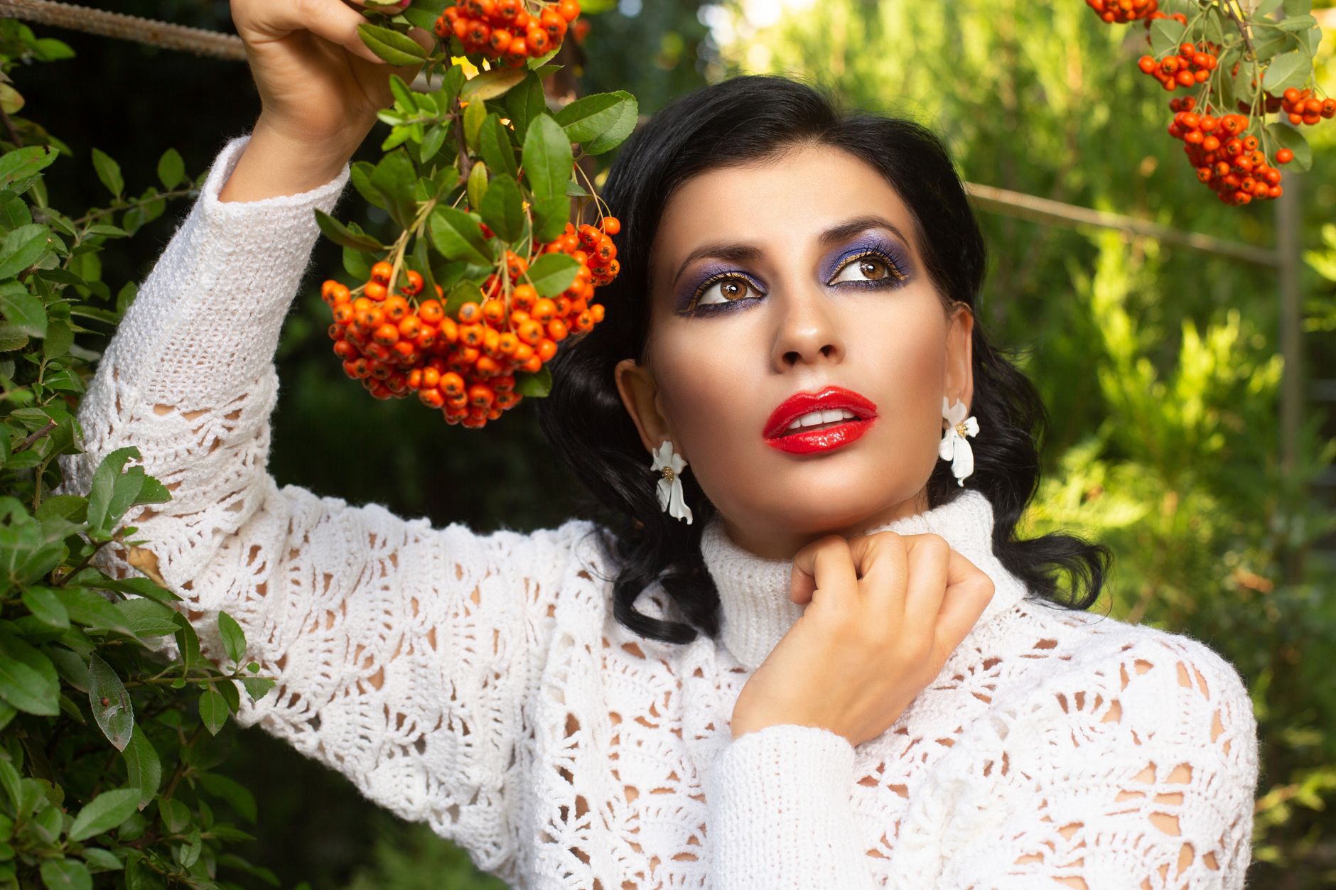 Stylish woman in white blouse posing with colorful pyracantha berries outdoors. — Create Constant Ai Video Characters: Pr