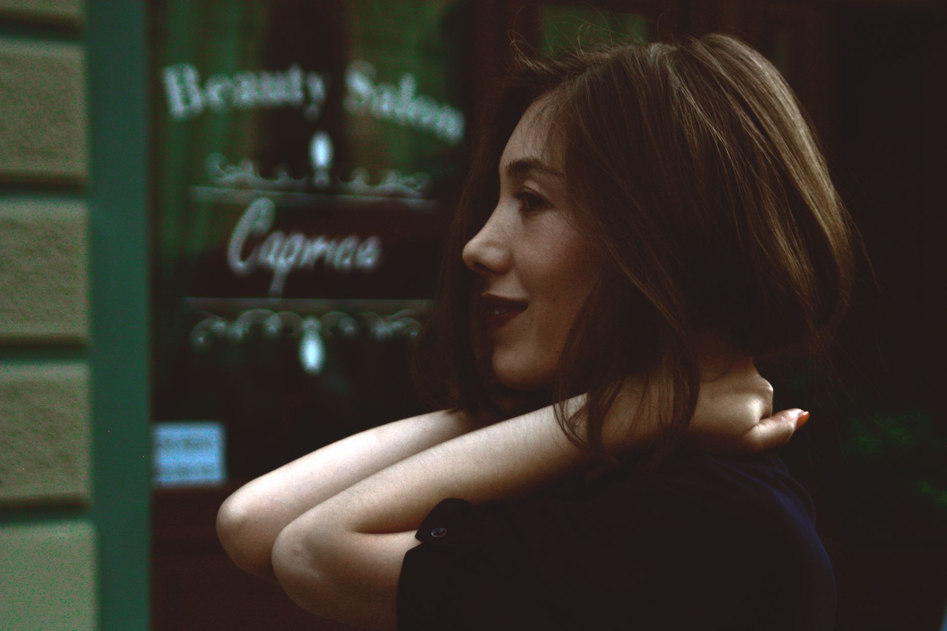 Side view of a smiling woman in front of a beauty salon, showcasing happiness and style. — Free Random Video Chat Omegle