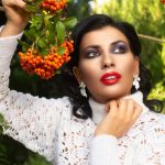 Stylish woman in white blouse posing with colorful pyracantha berries outdoors. — Make Communication Easy with Property Manag